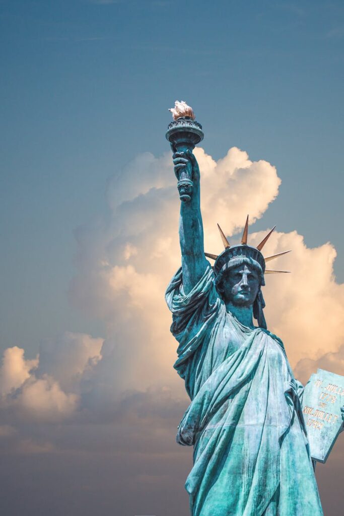 Iconic Statue of Liberty with majestic clouds in New York, USA. Perfect travel destination image.